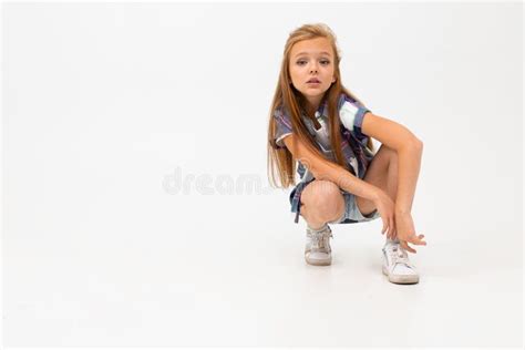 Attractive Girl Squatting On A White Background With Copy Space Stock