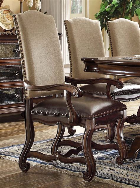 Upholstered dining chairs serve several purposes in the dining room. Set Of 2, Coruna Upholstered Wood Arm Chairs W/ Nailhead Trim