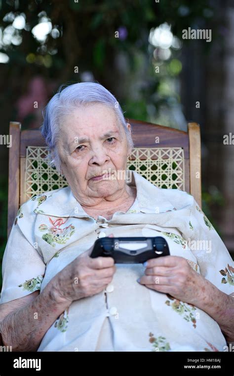 Upset Grandma With Game Joystick Playing Videogames Stock Photo Alamy