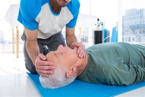 Paramedic Practising Resuscitation Mouth To Mouth On Dummy Stock Photo