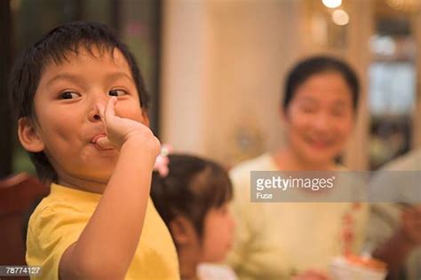 Asian Woman Licking Finger Stock Fotos Und Bilder Getty Images