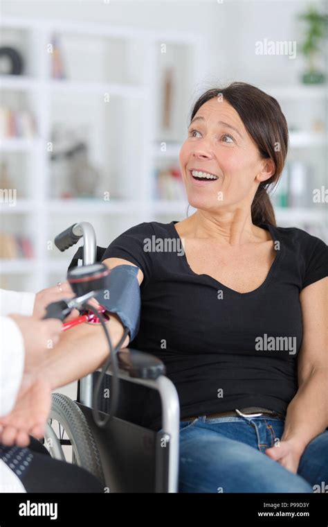 Disabled Woman Having Blood Pressure Measured Stock Photo Alamy
