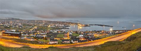 When visiting the faroes you are never more than 5 km (3 mi) away from the ocean. Torshavn city panoramic view summer night. Faroe islands capital town. Stock Photo by ABBPhoto