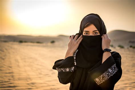 Portrait Of Arab Woman In Hijab Clothing Standing In The Desert Stock