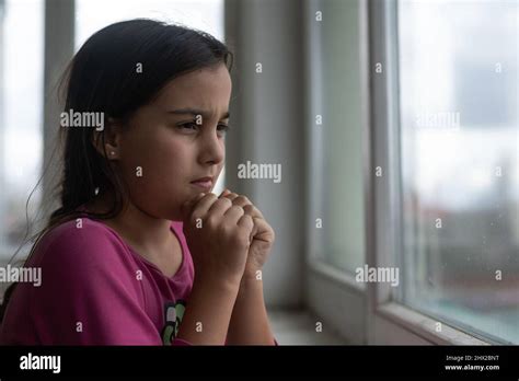 Praying Little Girl Near Window Stock Photo Alamy