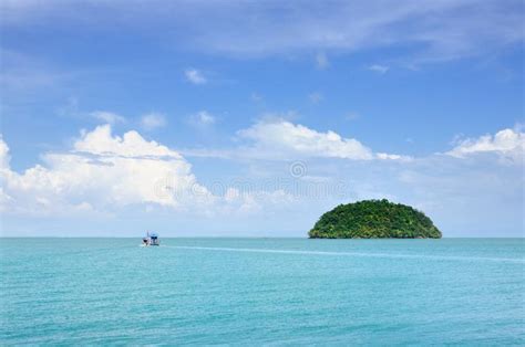 Turquoise Tropical Sea With Fishing Boat And Small Island On Horizon