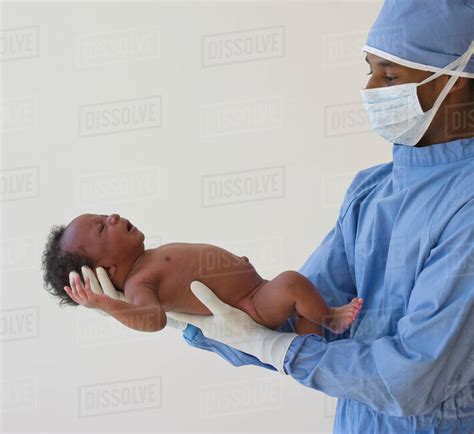 Doctor Holding Baby Stock Photo Dissolve