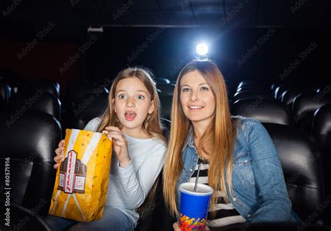 surprised mother and daughter watching film stock foto adobe stock