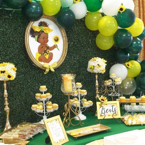 The Dessert Table Is Decorated With Sunflowers And Cupcakes