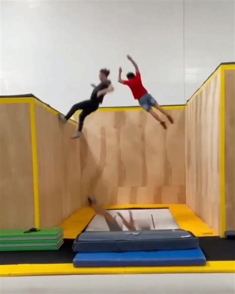 Three Guys Enjoy Themselves While Performing Tricks On Wall Trampoline