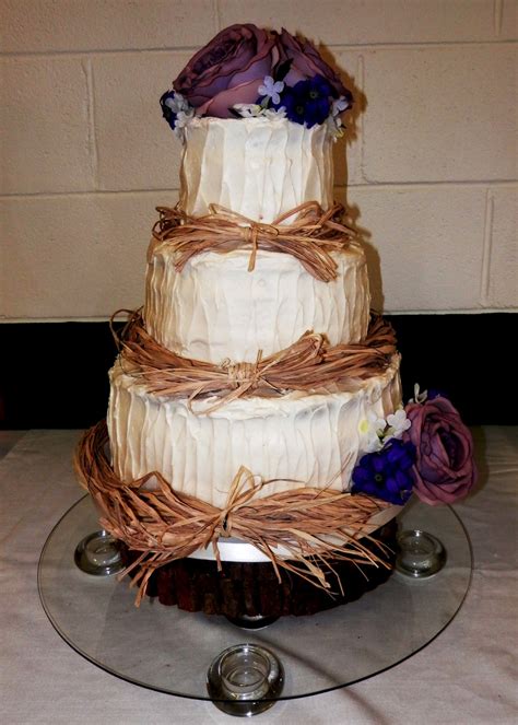 Simple, tiered white wedding cakes aren't the only option on the wedding dessert menu anymore, and we can't wait to see what imaginative designs you can't hold a good trend down, right? Rustic Wedding Cake With Raffia Top Amp Bottom Tiers Are Vanilla With Vanilla Butter Cream ...