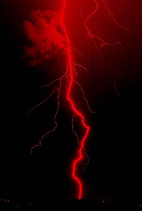 A Red And Black Photo Of A Lightning Strike