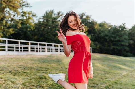 Shapely Lovable Girl In Red Outfit Posing In Park With Pleasure