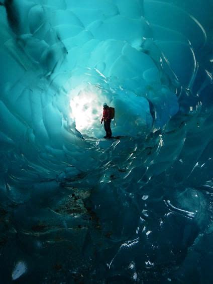 A Photo Of A A Hiker Stops Inside The Mendenhall Glacier Caves Tongass