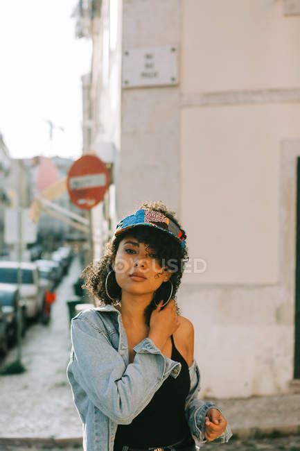 Fashionable African American Woman In Tank Top And Unbuttoned Denim