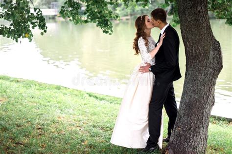 Happy Bride And Groom At A Park On Their Wedding Day Stock Image