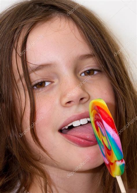 Little Girl With Colorful Lollipop — Stock Photo © Photojog 7136855