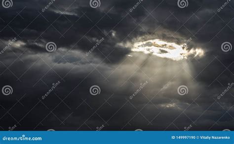 The Sun`s Rays Shine Through A Hole In The Continuous Cloud Cover Stock