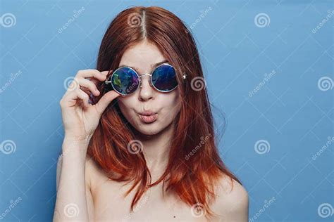 Perky Red Haired Woman In Blue Glasses Bare Shoulders Posing Stock