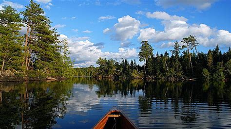 In A Canoe On Quiet Spoon Lake Boat Montana Clouds Trees Usa Sky