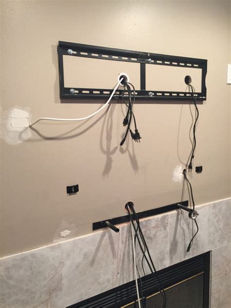 Tv Mounting Over A Fireplace With Wires Concealed In The Wall