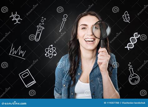 Emotional Student Laughing And Holding A Magnifying Glass Stock Photo