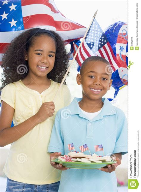 Brother And Sister On Fourth Of July With Flags And Cookies Smiling Holiday Weather Weather