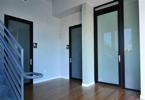 Example of a dark gray door with frosted windows. Swing Doors, Glass Swing Doors | SpacePlus LLC