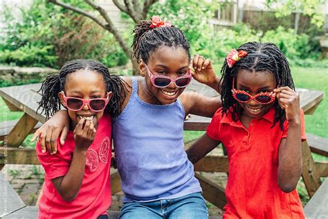 view three black girls on a bench with sunglasses by stocksy contributor gabriel gabi