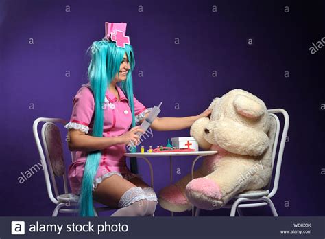 Woman Wearing Nurse Costume Holding Syringe By Teddy Bears On Chair Against Purple Background