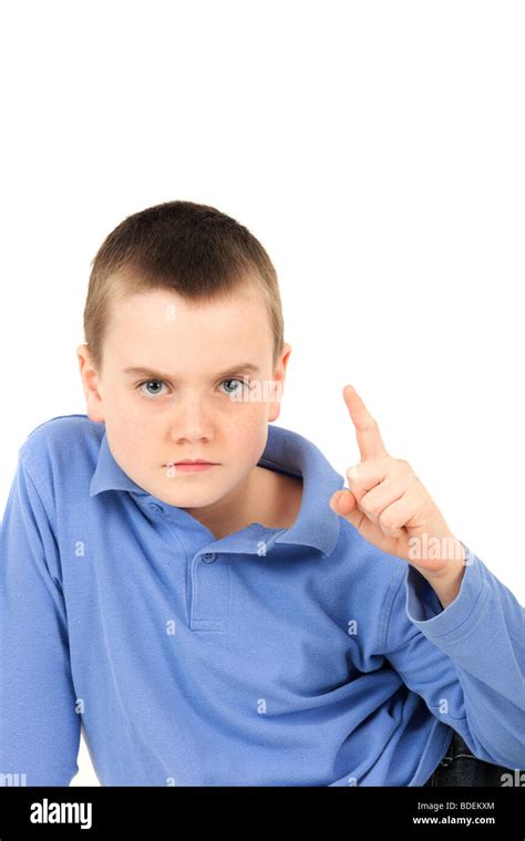 Portrait Of Young Boy Pointing Finger Against White Background Stock