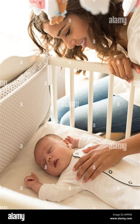 Mother Putting Baby To Sleep At The Crib Stock Photo Alamy