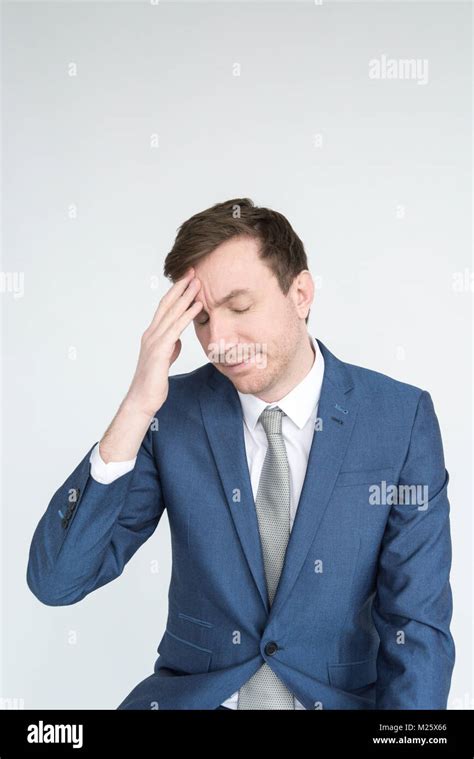 Portrait Of A Smartly Dressed Man With His Hand On His Chin Like He Is