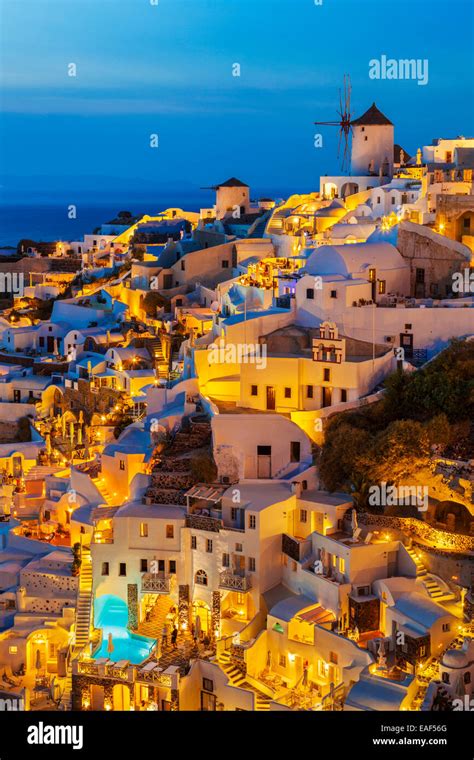 Windmill And White Houses At Night In The Village Of Oia Santorini