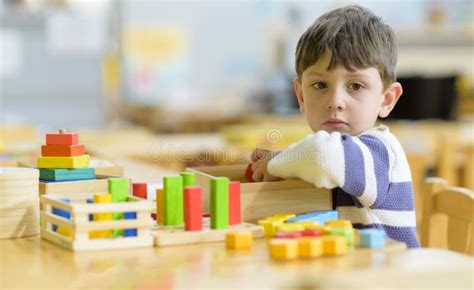Cute Little Boy Playing At Kindergarten With Construction Toy Stock