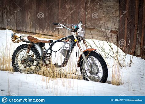 Old Antique Motorcycle Parked In The Snow Winter Time Outside Stock