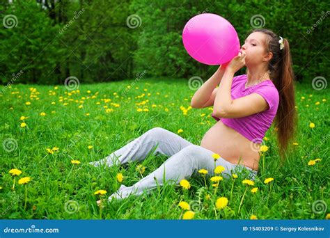 Beautiful Pregnant Woman Blowing Balloon Royalty Free Stock Images