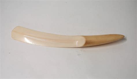 A Wooden Banana Sitting On Top Of A White Table