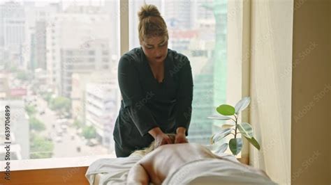 Biracial Woman Masseuse In A Luxury Spa Performs Shoulder And Neck