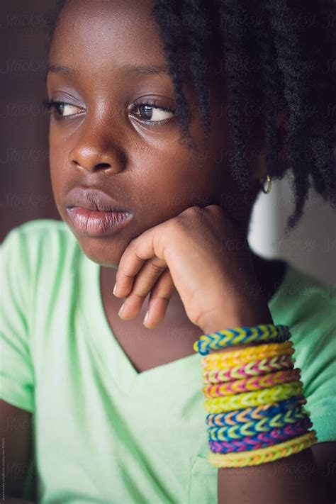 A Young Girl With Her Hand Under Her Chin Del Colaborador De Stocksy