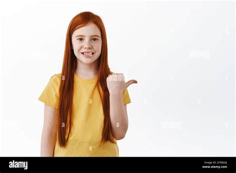 Happy Cute Little Redhead Child Pointing Finger Aside Ginger Girl With