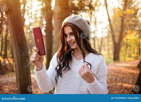 Young Beautiful Smiling Caucasian Woman Taking Selfie On Cellphone In Autumn Park A Good Sunny