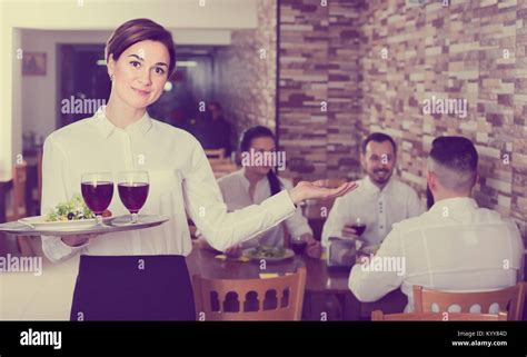 Smiling Woman Waitress Carrying Order For Guest In Country Restaurant