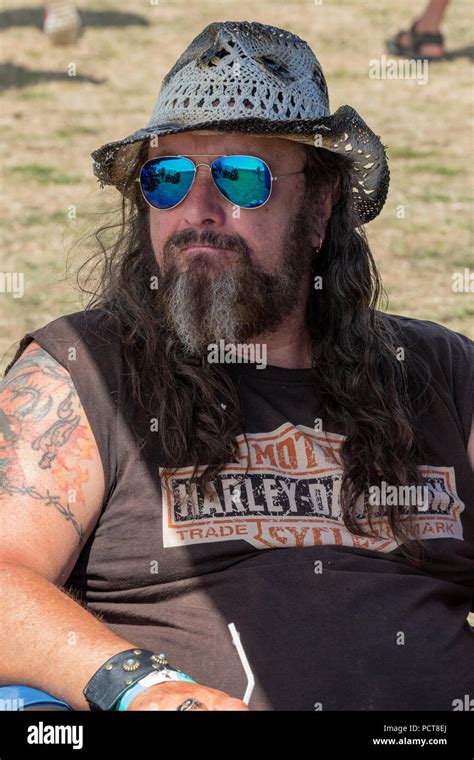 A Hairy Biker With A Large Long Beard Wearing Sunglasses