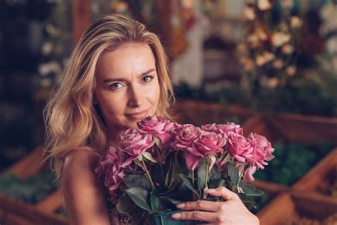 Free Photo Portrait Of Pretty Young Woman Holding Pink Rose Bouquet