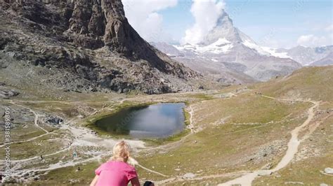 Mount Matterhorn Reflected On Riffelsee Lake Tourist Woman Relaxing