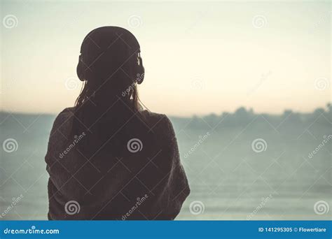 Silhouette Of Naked Woman With Wet Hair Wrapped In A Blanket After