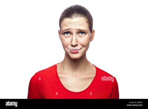 Portrait Of Sad Unhappy Woman In Red T Shirt With Freckles Studio Shot