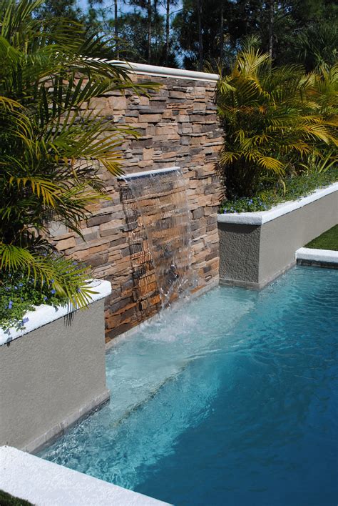 Stone Privacy Wall With Waterfall Into Pool Architecture Details
