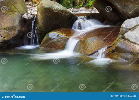 Beautiful Tranquil Waterfall Among The Rocks Of Mountain Creek Stock